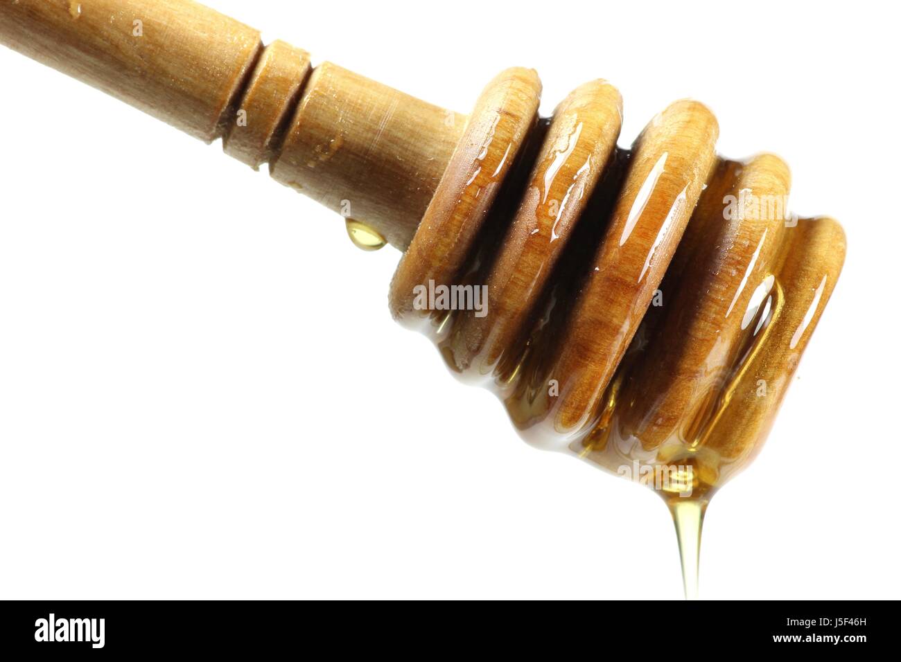 Honig-Löffel gemacht von Olivenholz vor weißem Hintergrund Stockfoto