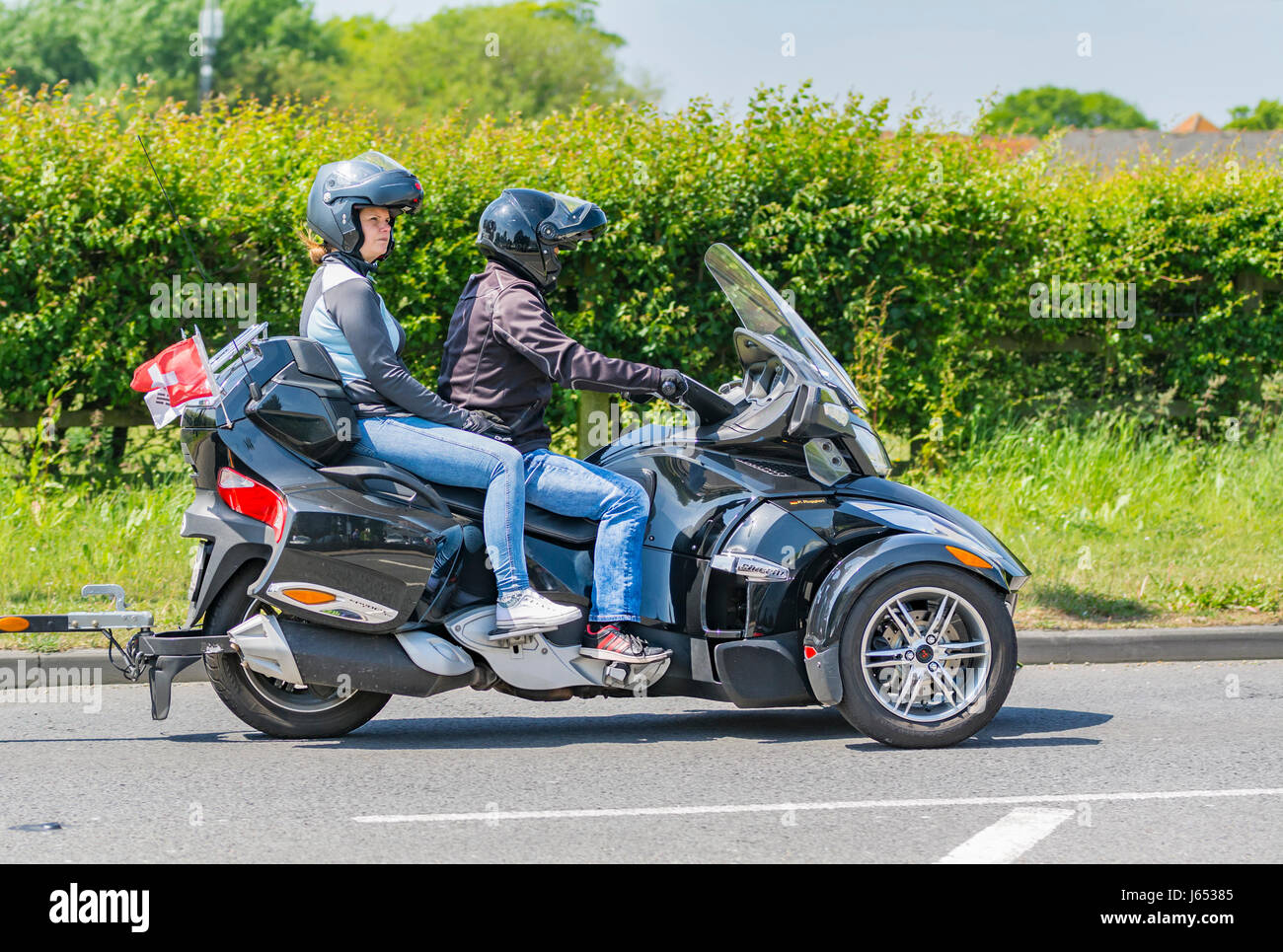 Motorradfahrer mit Sozius auf einer Landstraße im Vereinigten Königreich. Stockfoto