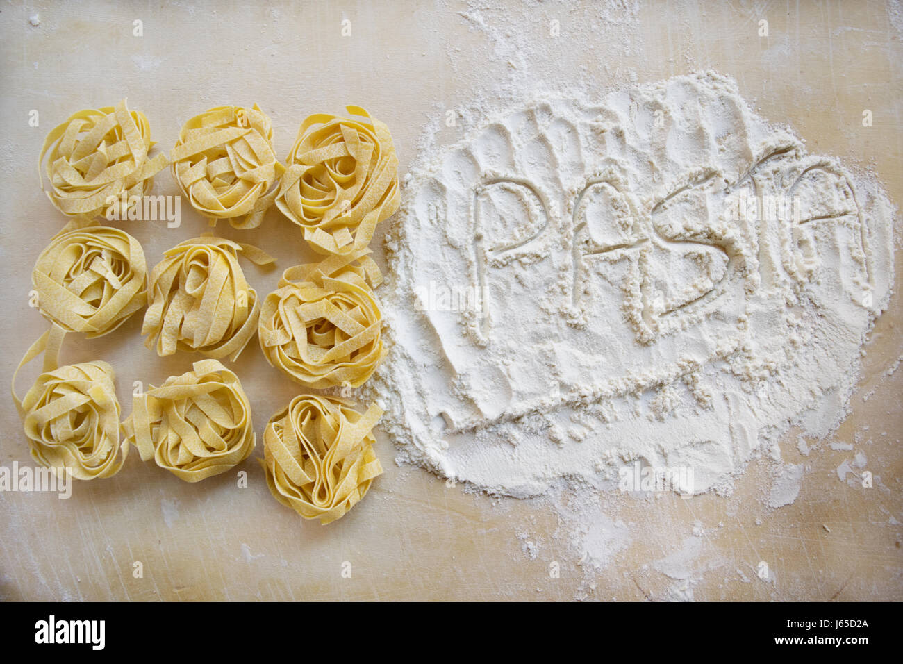die Wort-Pasta mit dem Mehl Neben einigen Tagliatelle geschrieben Stockfoto