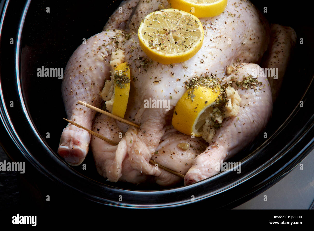 Gefüllte Hähnchen, Zitrone und Kräutern in einem langsamen Kocher. Stockfoto