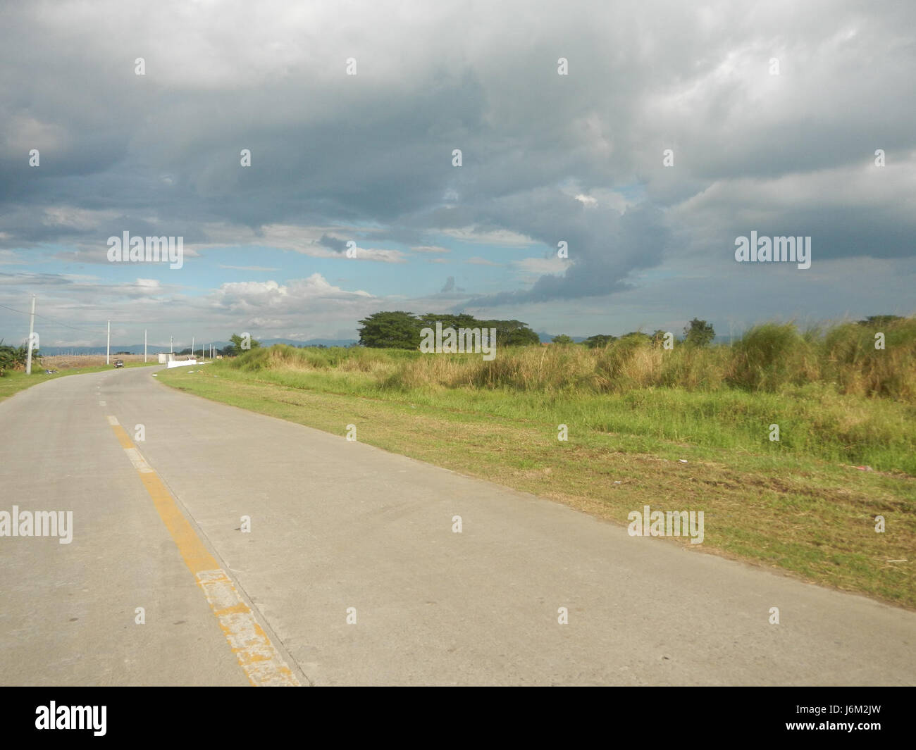 Dieses Bild bezieht sich auf die landwirtschaftliche Landschaft von Candaba, Pampanga, mit Reisfeldern, Hängen und Straßen in den Gebieten Salapungan und Magumbali, typisch für die landwirtschaftlichen Praktiken der Region. Stockfoto