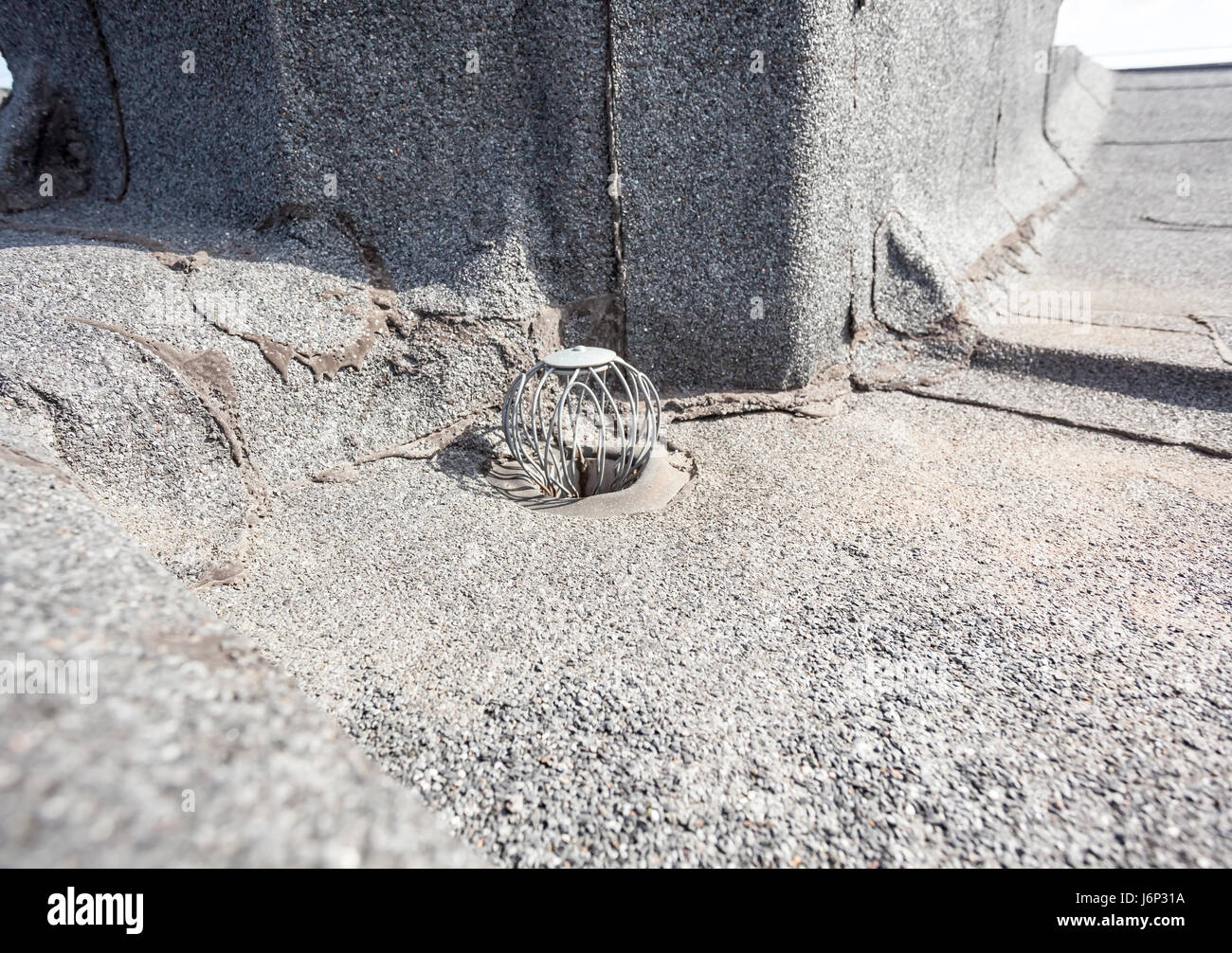auf ein Flachdach ist Abfluss, um gegen Blätter halten Stockfoto