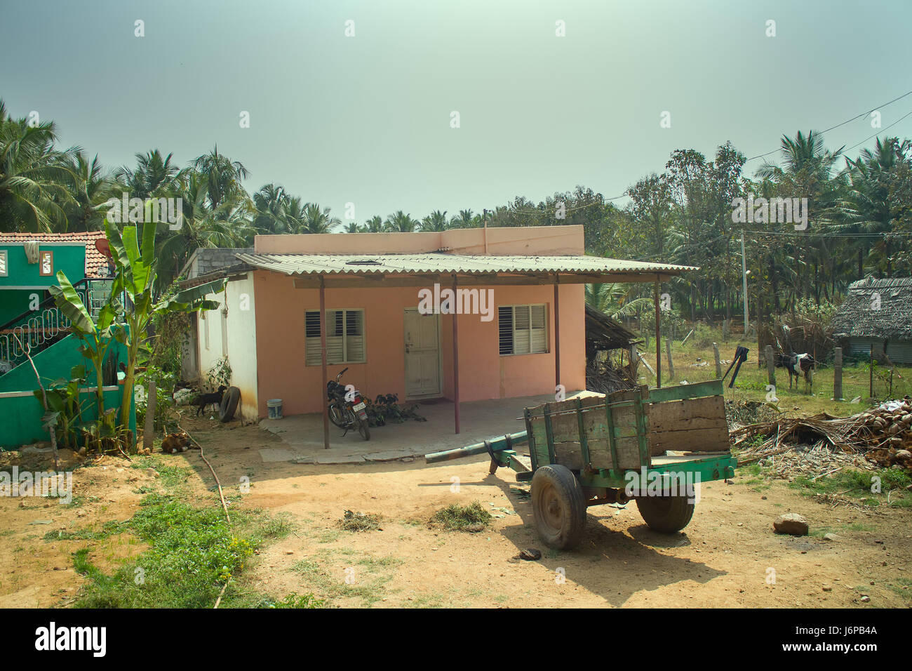 Wohnung in der indischen Provinz. Hof, Haus und Haus-service indischen Armut. Motorrad, Wagen mit menschlichen Tier Traktion Stockfoto