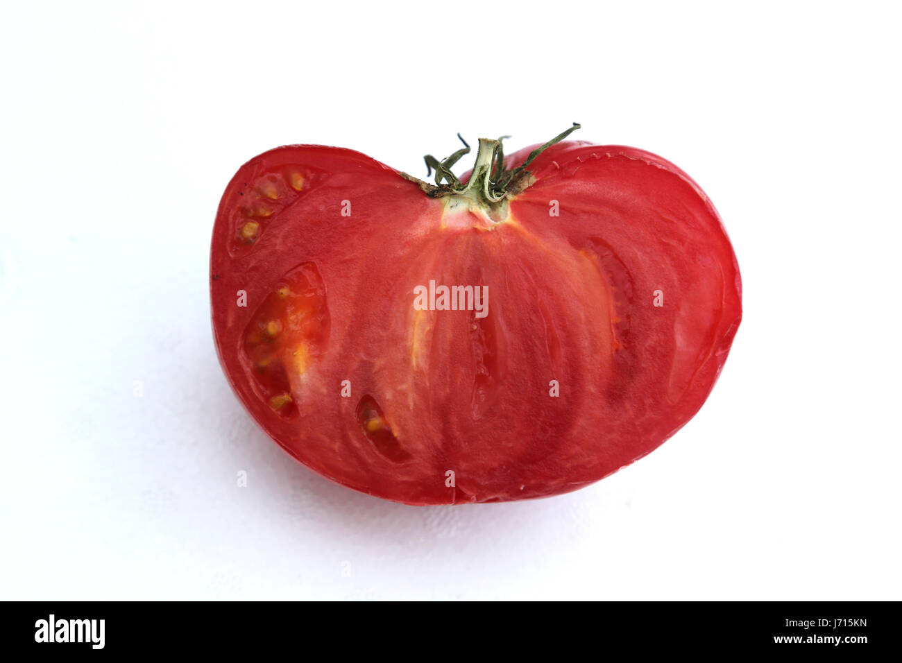 die Hälfte einer großen Tomate Stockfoto