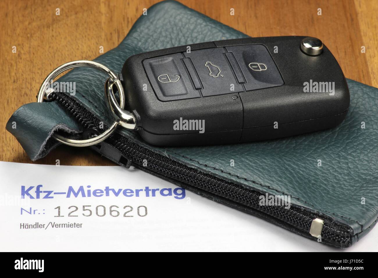 Autoschlüssel und deutsches Auto Mietvertrag auf desktop Stockfoto