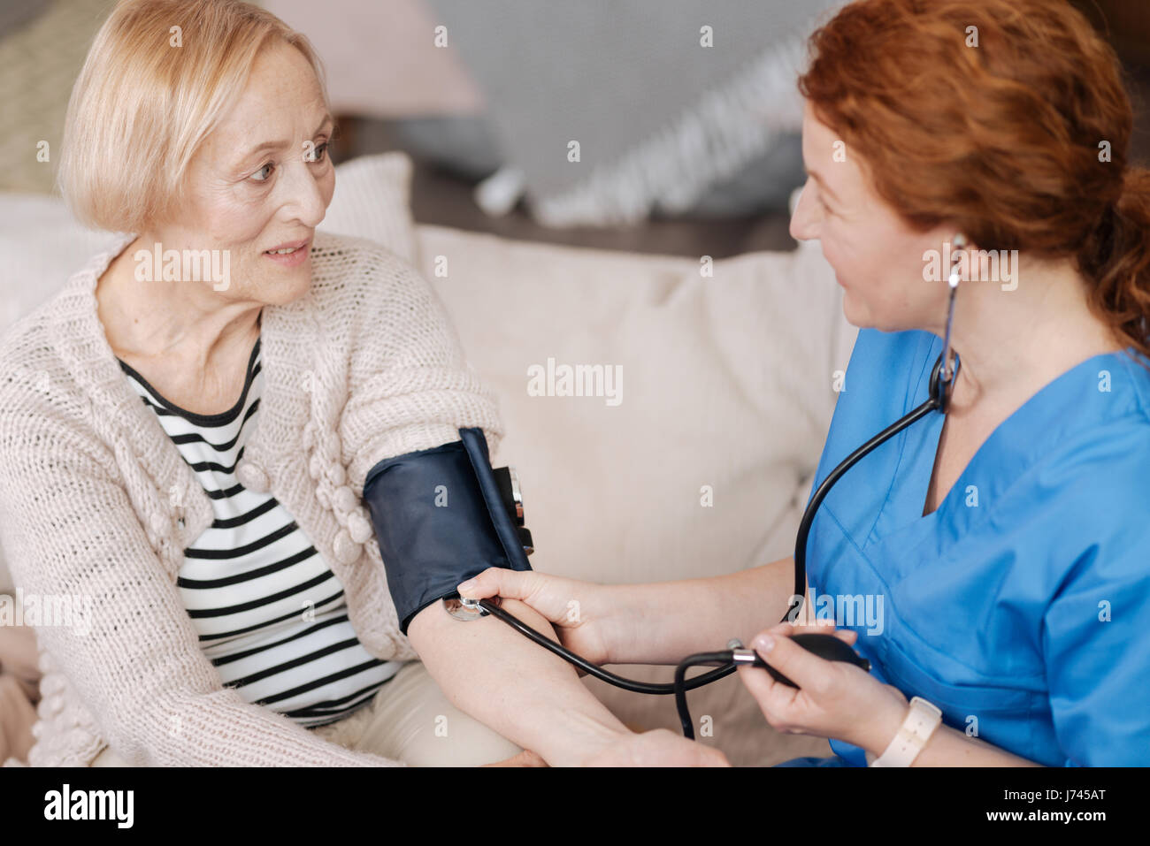 Sanfte eingedenk Krankenschwester beschäftigt Blut Drucksensor Stockfoto