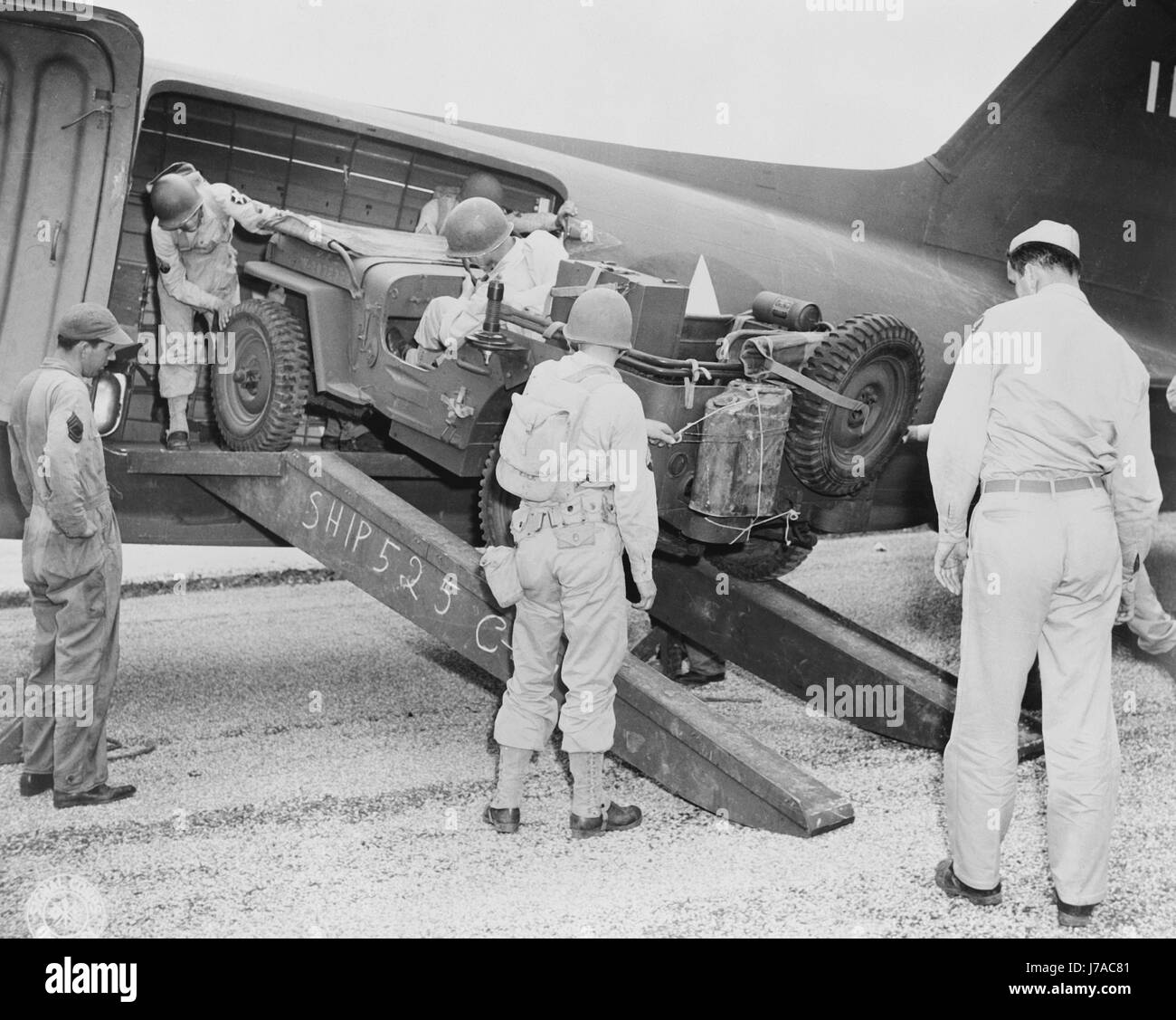 Ein Jeep ist in einer Ebene, ca. 1942 geladen. Stockfoto