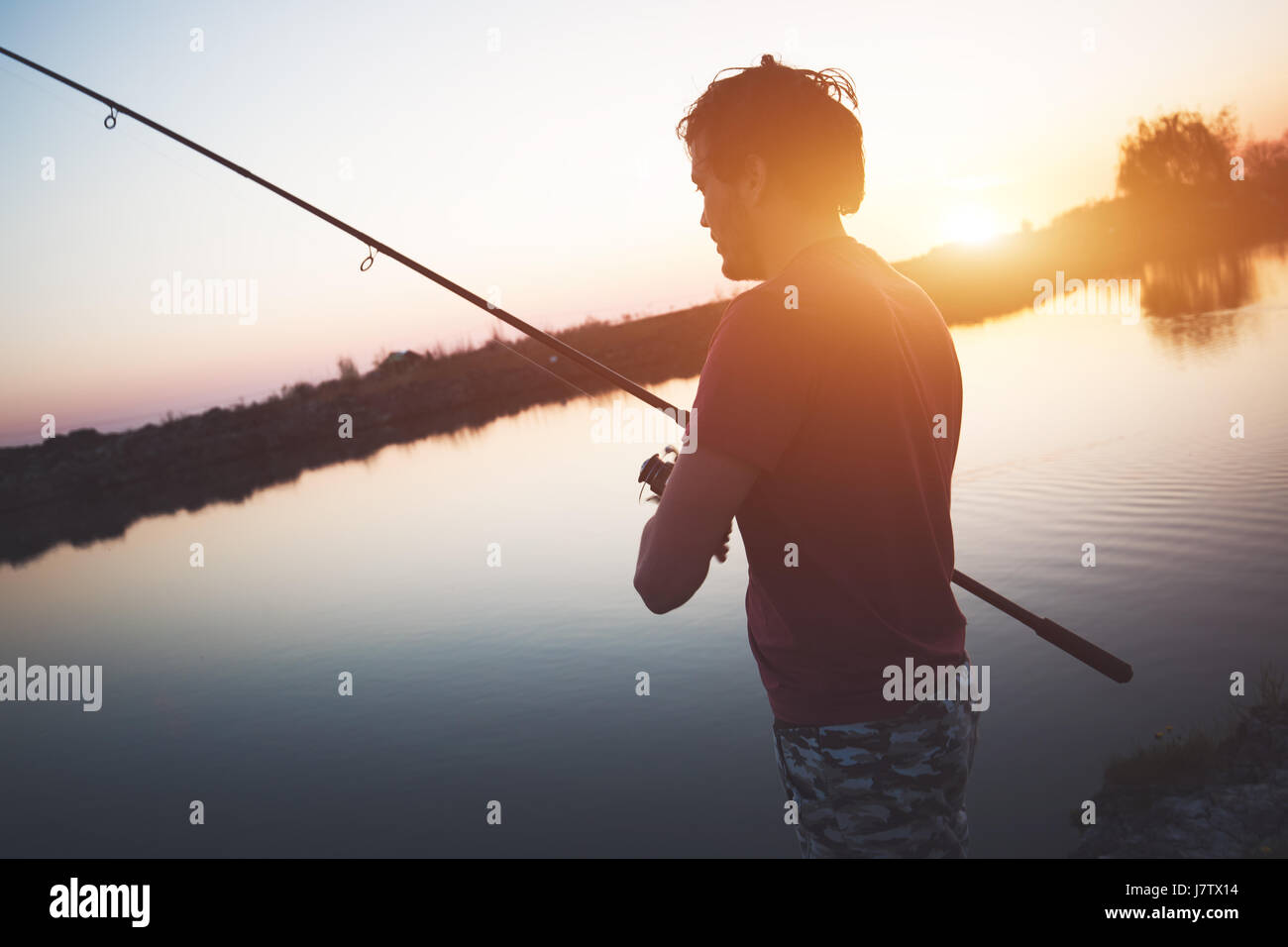 Junger Mann Angeln im Teich und genießen hobby Stockfoto
