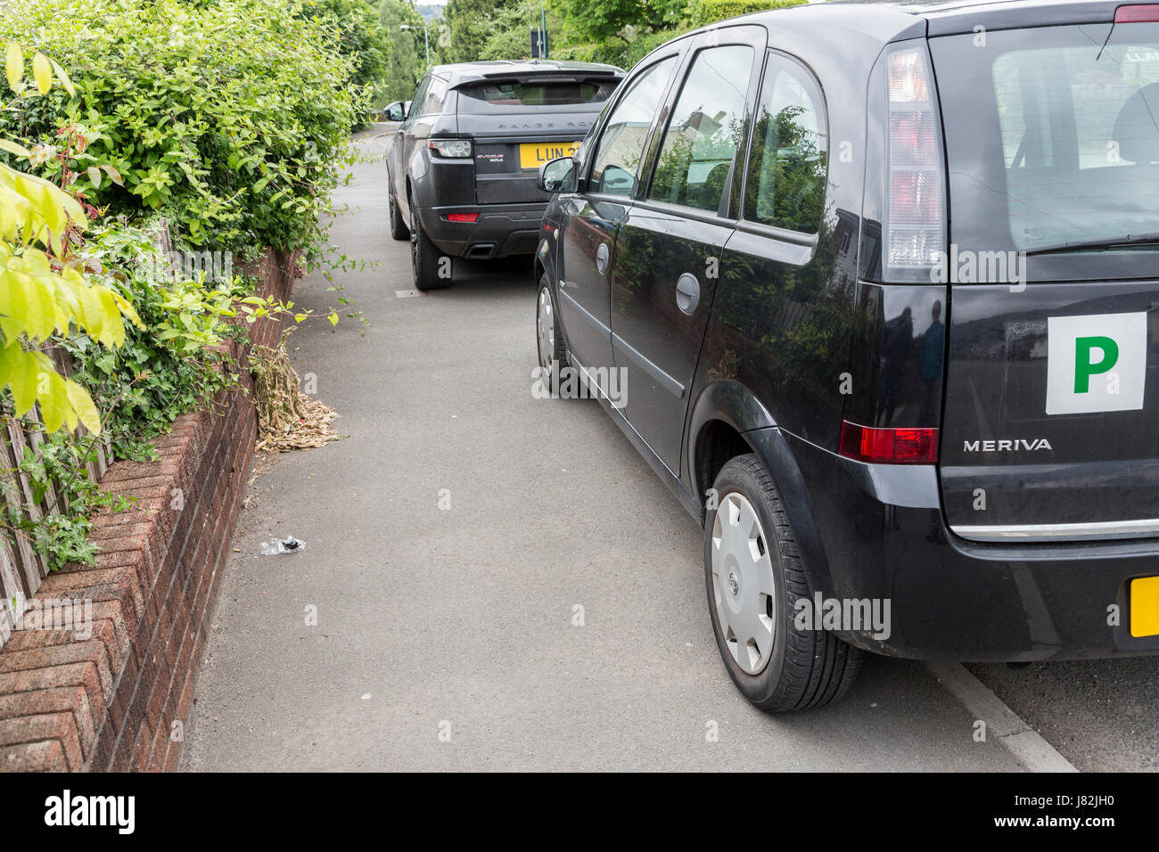 Parken auf Gehweg behindern Zugang für Fußgänger, Wales, UK Stockfoto