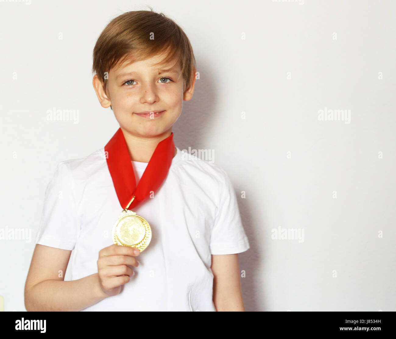Süße blonde junge mit Goldmedaillen-Gewinner Stockfoto