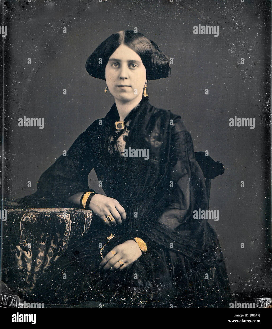 Dieses daguerreotype Foto zeigt eine schwarz gekleidete Frau, die die Mode des 19. Jahrhunderts widerspiegelt. Es zeigt die frühen Techniken der Fotografie und bietet einen Einblick in den Stil und die Kleidung der Zeit. Stockfoto