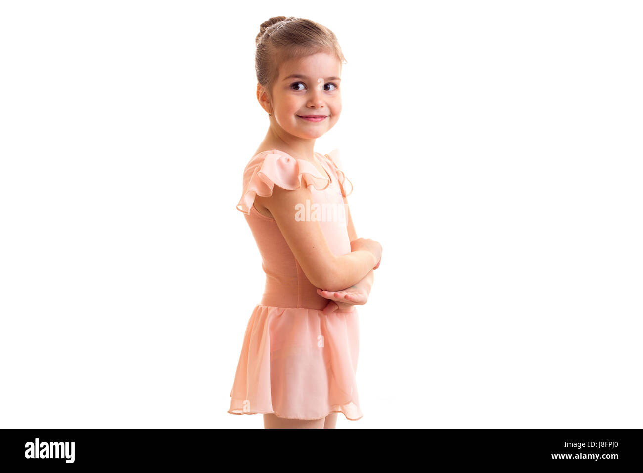 Wenig optimistisch Mädchen im rosa Kleid mit Tanz auf weißem Hintergrund im Studio bundle Stockfoto