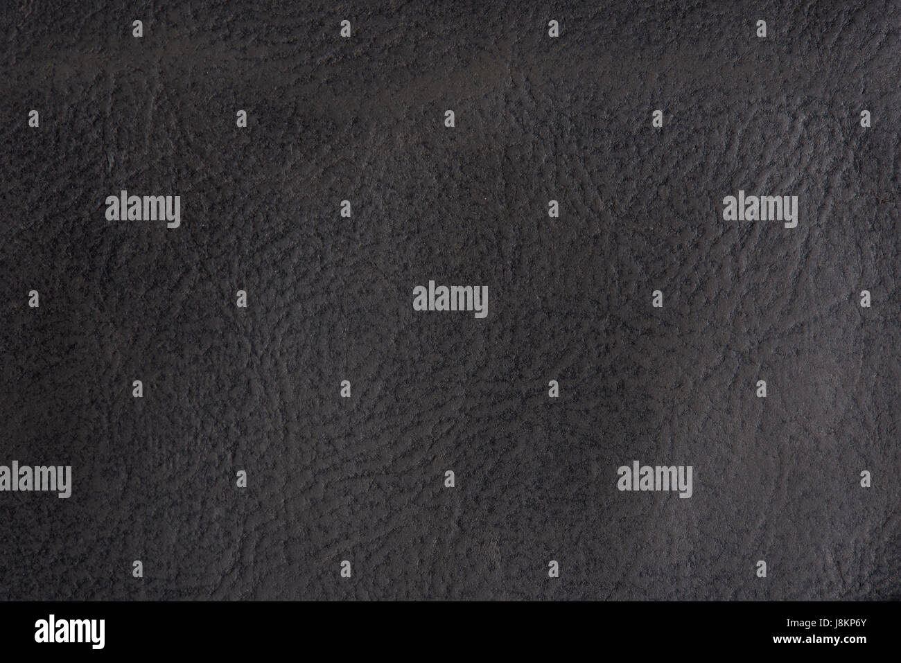 Alte Leder natürliche Grunge Hintergrund Nahaufnahme. Makroaufnahme einer dunklen Hauttextur Stockfoto