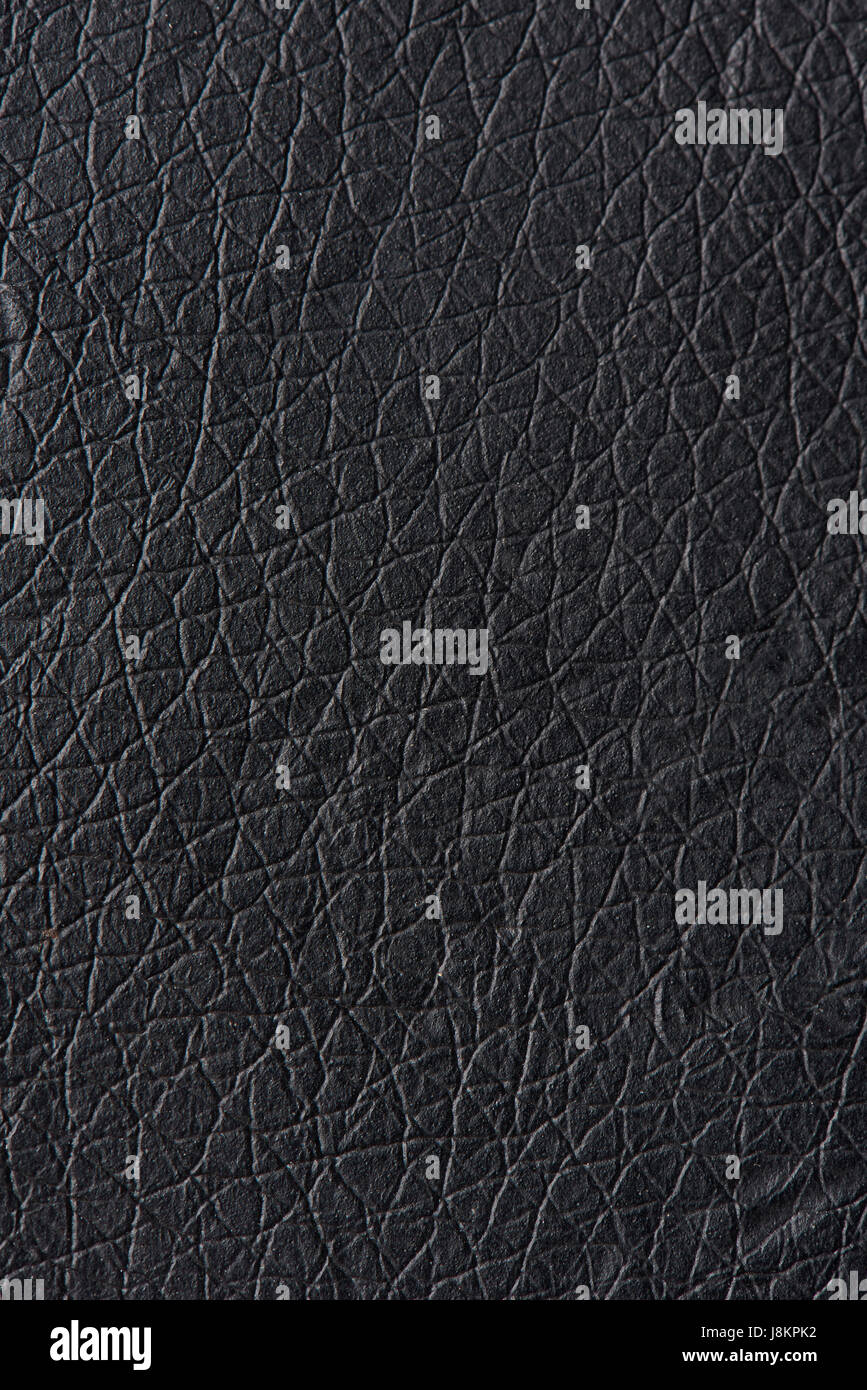 Muster aus schwarzem Leder-Oberfläche. Makroaufnahme einer schwarzen Hautstruktur Stockfoto