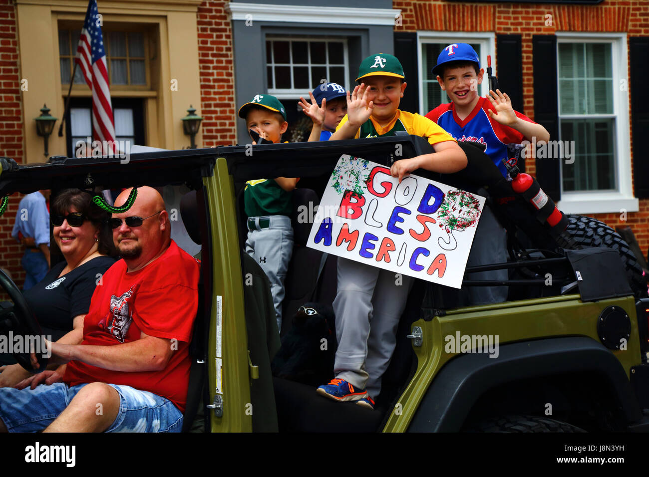 Westminster, Maryland, USA. 29. Mai 2017. Schuljungen halten eine handgefertigte God Bless America Plakat und Welle, wie sie Paraden für Memorial Day, ein Feiertag in den Vereinigten Staaten für das Gedenken an die verstorbenen während des Dienstes in den Streitkräften des Landes teilnehmen. Bildnachweis: James Brunker/Alamy Live-Nachrichten Stockfoto