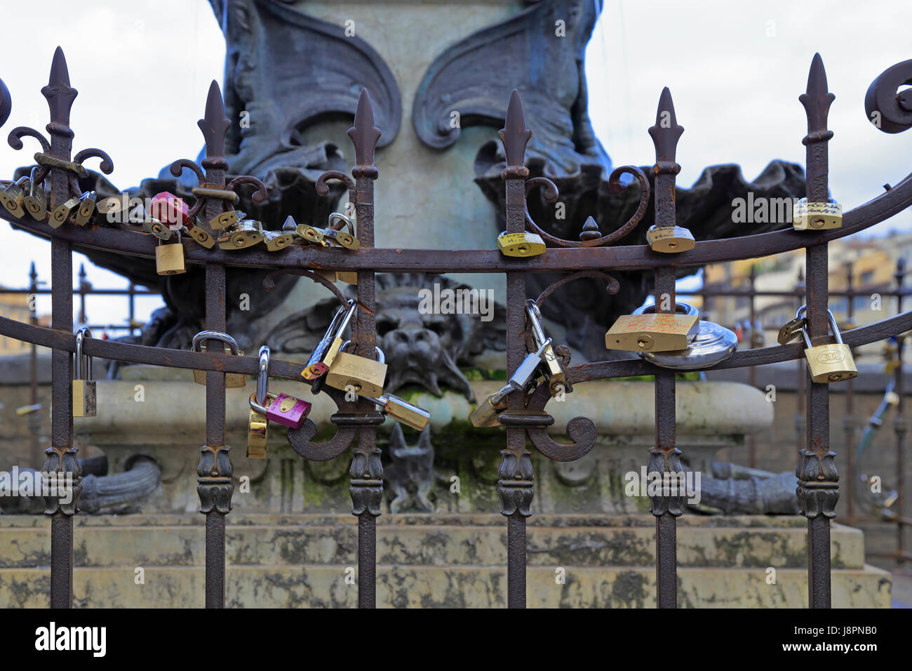 Liebesschlösser auf dem Geländer rund um Cellinis Büste auf dem Ponte Vecchio, Florenz, Toskana, Italien, Europa. Stockfoto