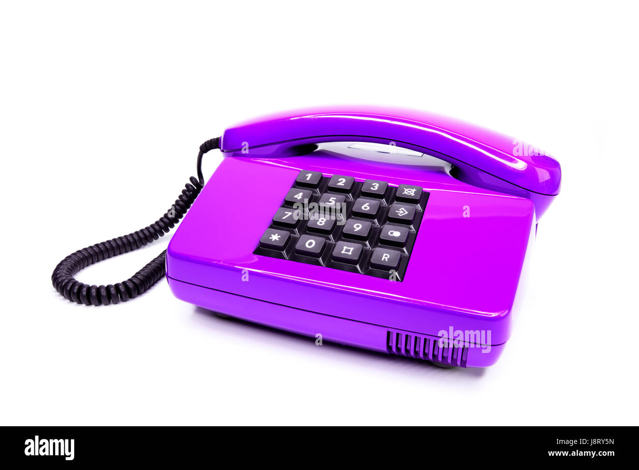 klassische lila Telefon aus den Achtzigern, isoliert auf weißem Hintergrund Stockfoto