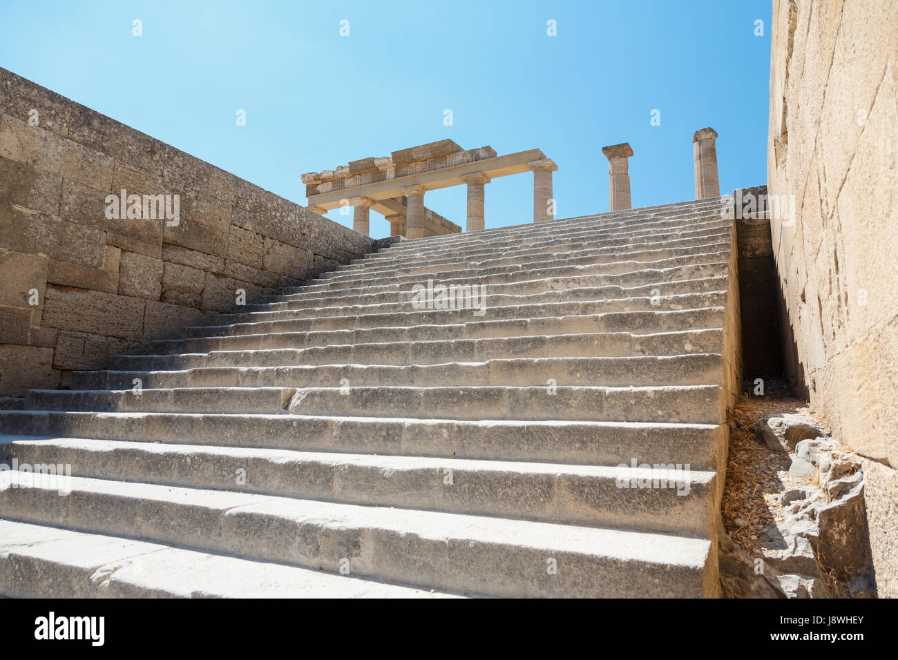 Alte steinerne Treppe führt auf die Kolonnade der großen hellenistischen Portikus der antiken Akropolis von Lindos, Rhodos, Griechenland Stockfoto