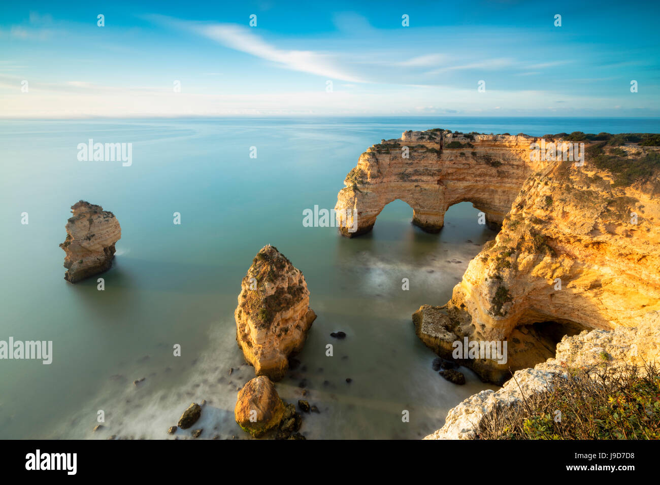 Sonnenaufgang auf Klippen umrahmt von türkisfarbenen Wasser des Ozeans, Praia da Marinha, Caramujeira, Gemeinde Lagoa, Algarve, Portugal Stockfoto