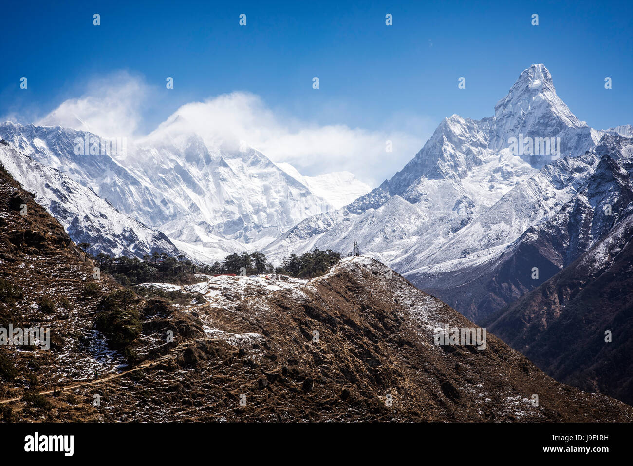 Ama Dablam steigt auf 6856 Meter im Sagarmatha Nationalpark, Nepal.  Mt. Everest und Lotse sind eingehüllt in Wolken auf der linken Seite. Stockfoto