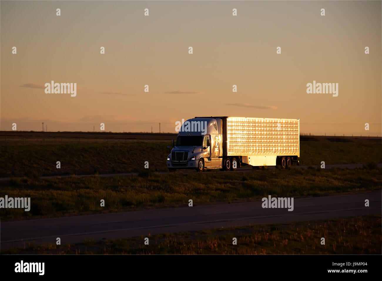 Große Lastwagen (LKW) reisen hinunter eine ländliche American Highway. Die meisten Markierungen und Marken wurden entfernt. Stockfoto