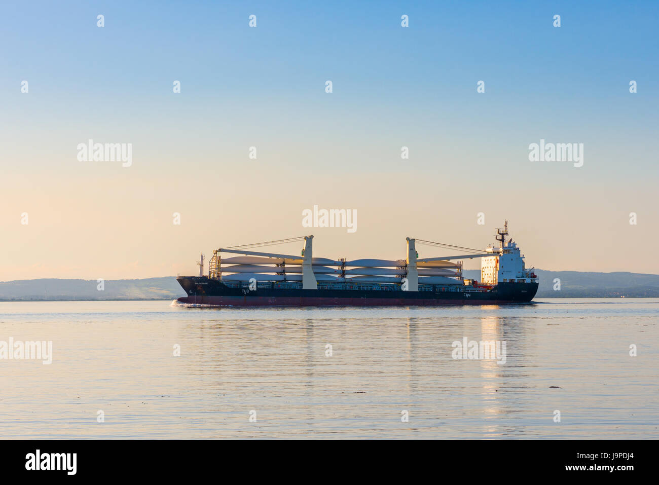 Der General Cargo ship BBC Rosario, Portishead, während Avonmouth Docks über den Severn Estuary, die Rotorblätter einer Windenergieanlage. Stockfoto