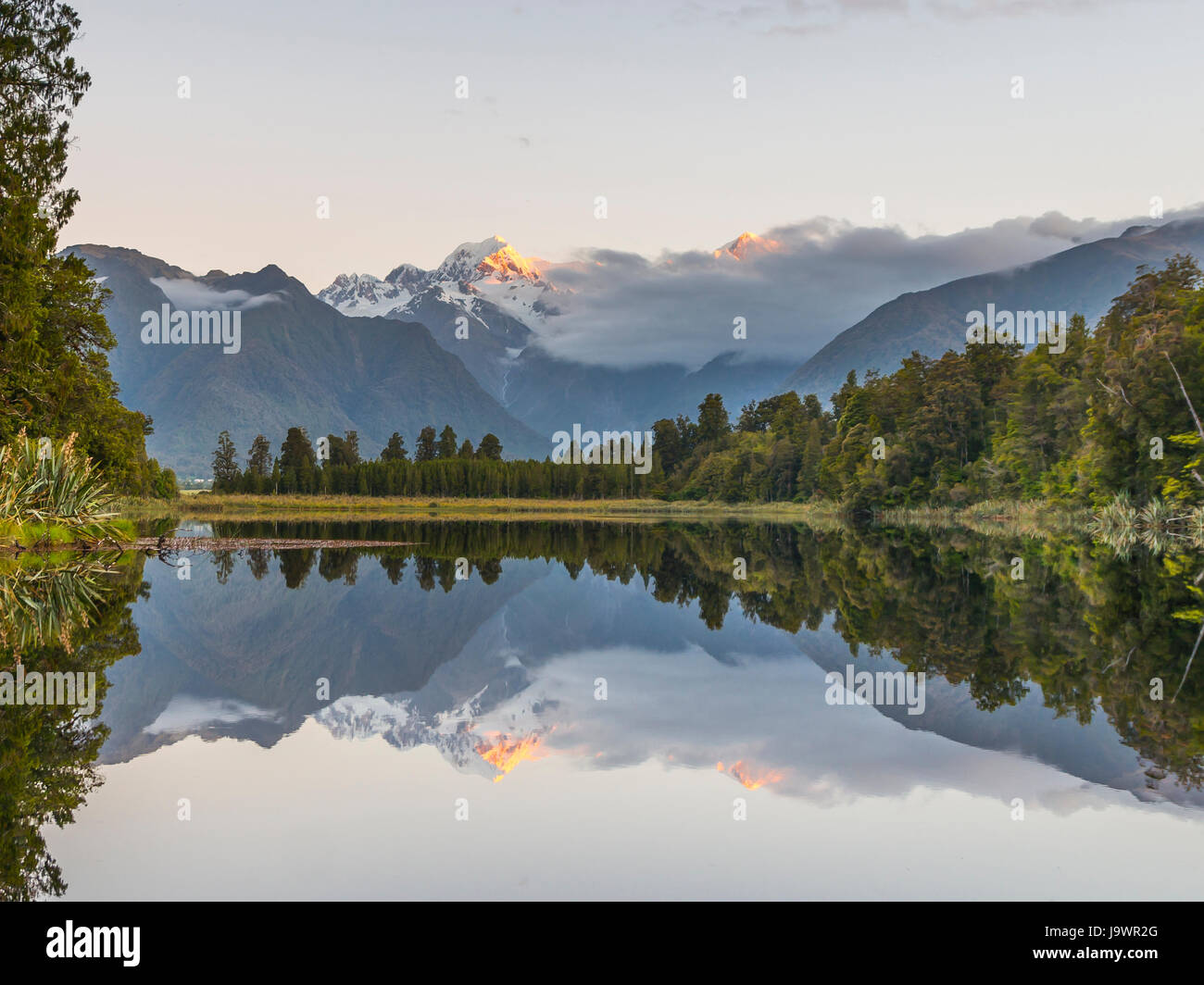 Sonnenuntergang, Spiegel-Insel, Mt. Tasman und Mt. Cook, Reflexion im Lake Matheson, Mount Cook Nationalpark Westland National Park Stockfoto
