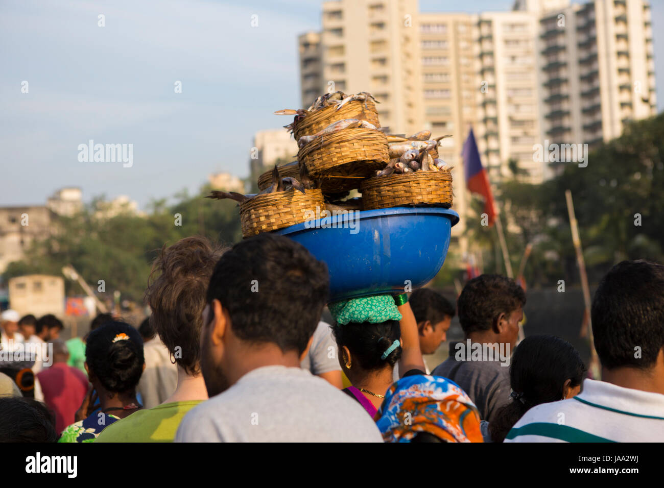 Körbe mit frischem Fisch auf einem Womans Kopf bei Sassoon Docks, Mumbai, Indien. Stockfoto