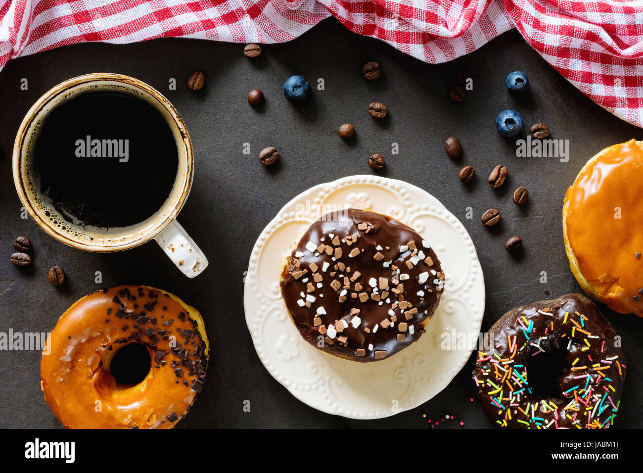 Leckere Donuts Schoko Karamell Zuckerglasur und Tasse schwarzen Kaffee ...