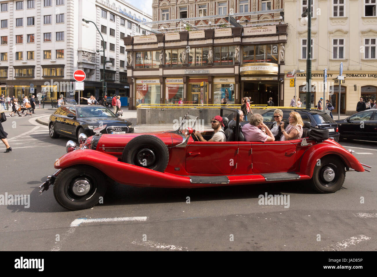 Touristen, die sightseeing in einer Oldtimer Alfa Romeo Spider-Limousine auf eine Tour durch Prag Stadtzentrum Stockfoto