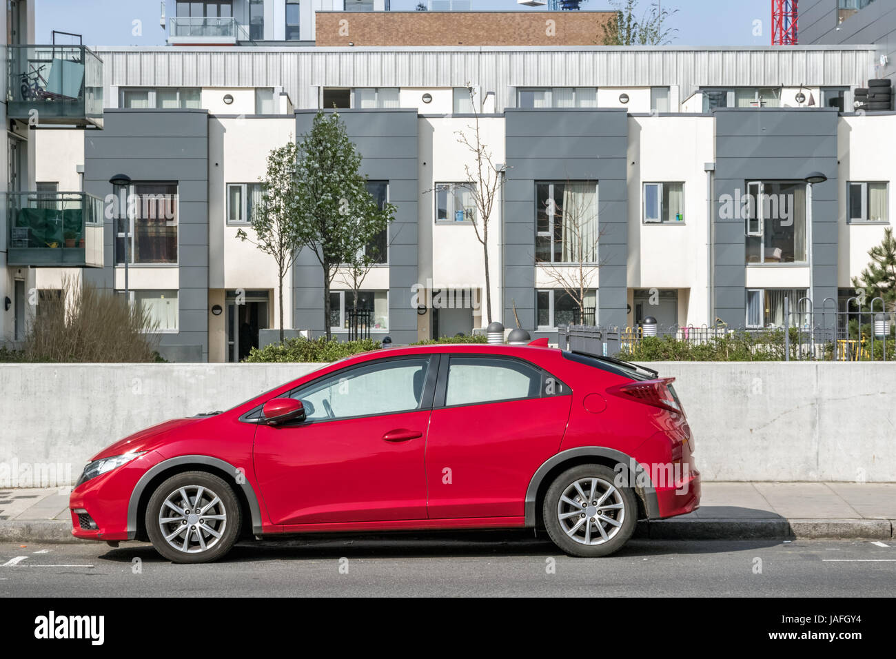 Eine rote Parkplätze auf der Straße vor einer modernen Wohnung Stockfoto