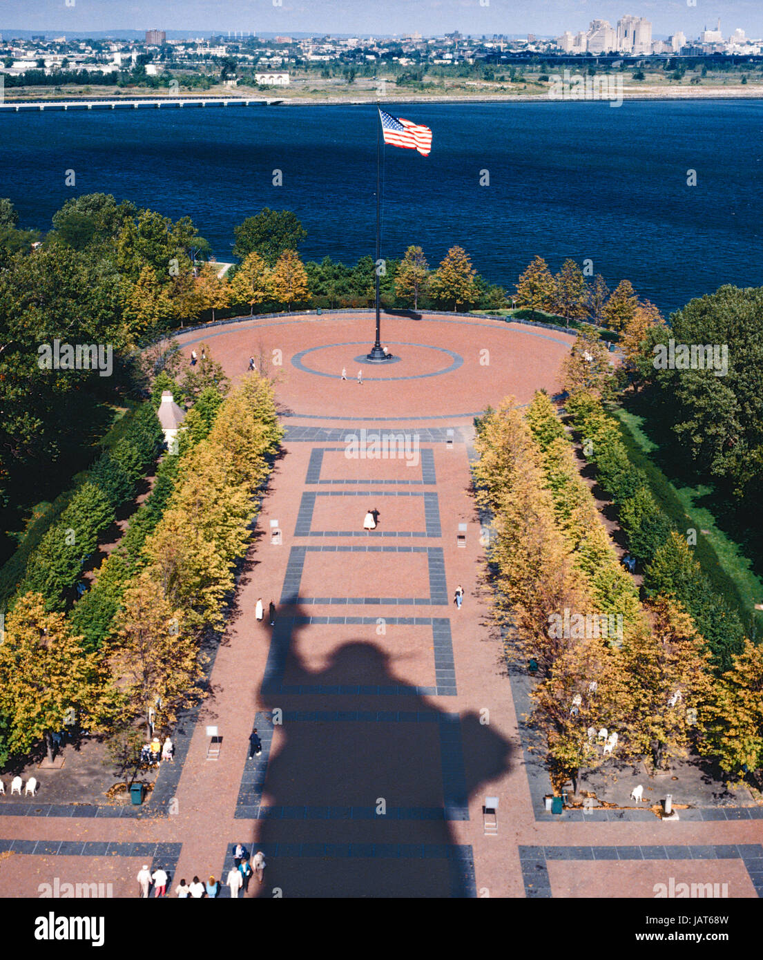Liberty Island, NY, USA - Oktober 1990: Besucher-Spaziergang auf der Plaza im Schatten der Statue of Liberty Stockfoto