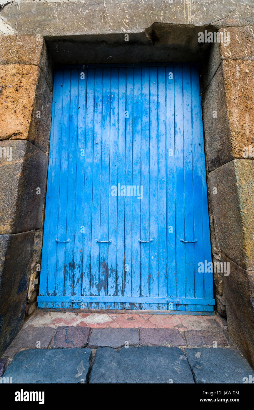 Eine blaue Holztür in ein Inka Trockenstein Torbogen Stockfoto