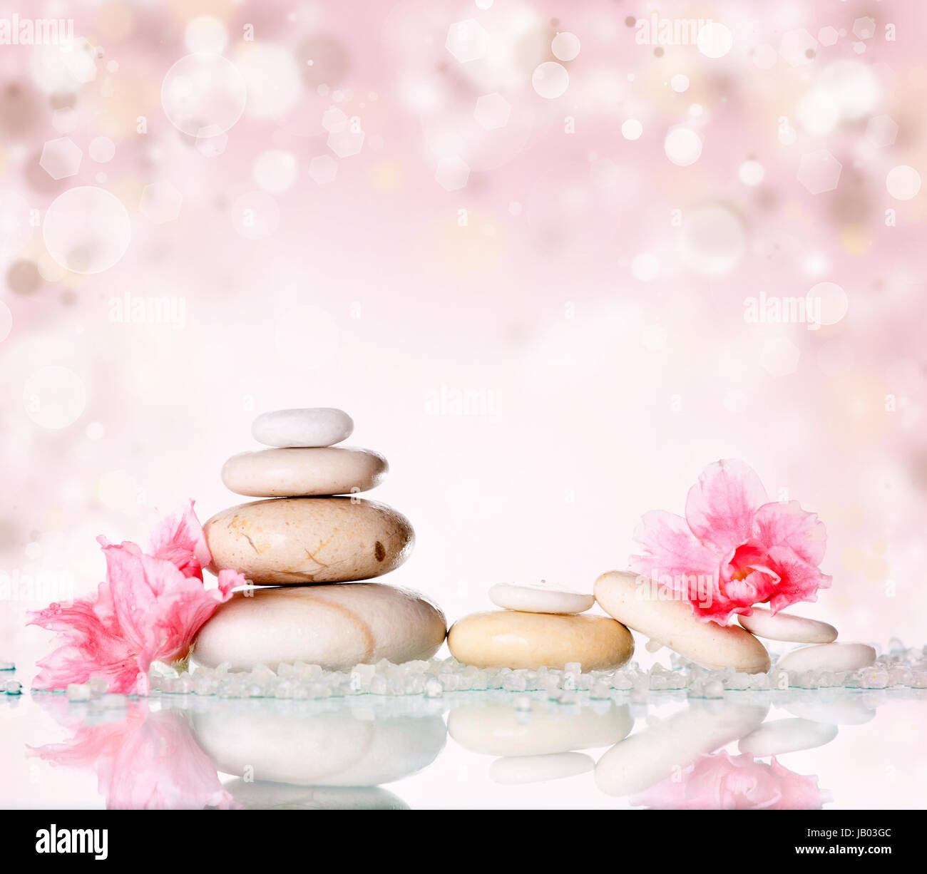 Spa-Steinen und rosa Blume auf abstrakte rosa Hintergrund Stockfoto