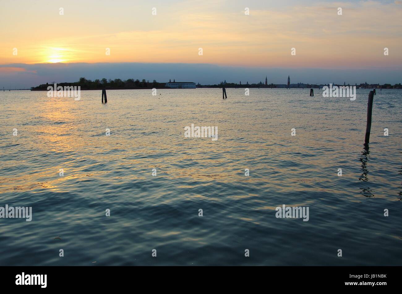Die Lagune von Venedig bei Sonnenuntergang, gesehen von der Insel Lido. Im Hintergrund die Insel Guidecca und die Silhouette von Venedig. Italien, Europa. Stockfoto