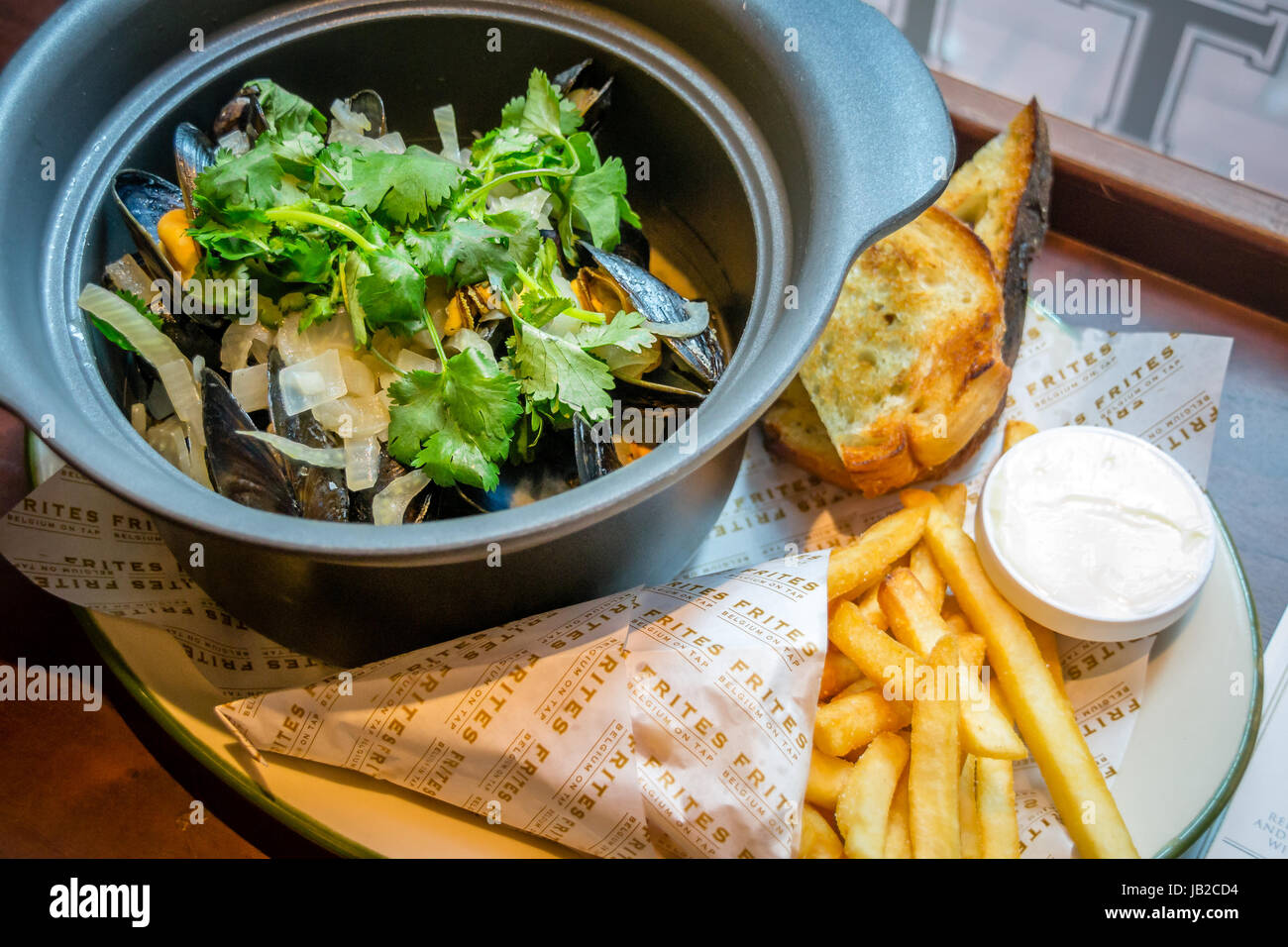 Hoegaarden Muscheltopf gehackt, Koriander, Fenchel, Zitronenschale und Hoegaarden Bier Pommes frites Stockfoto