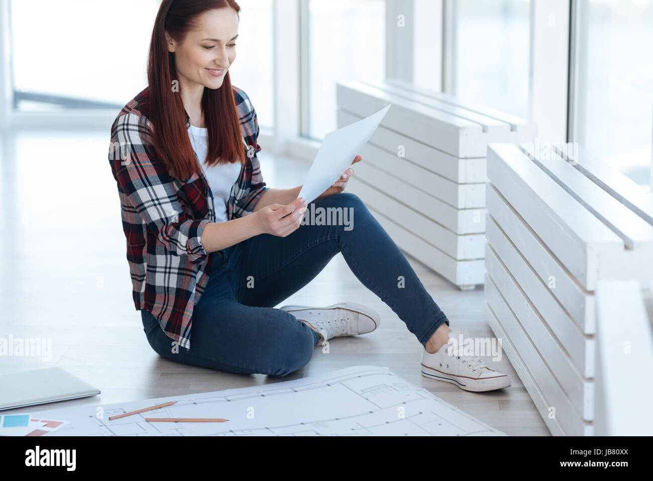 Fröhlich schöne Frau betrachten ihre Zeichnung Stockfoto