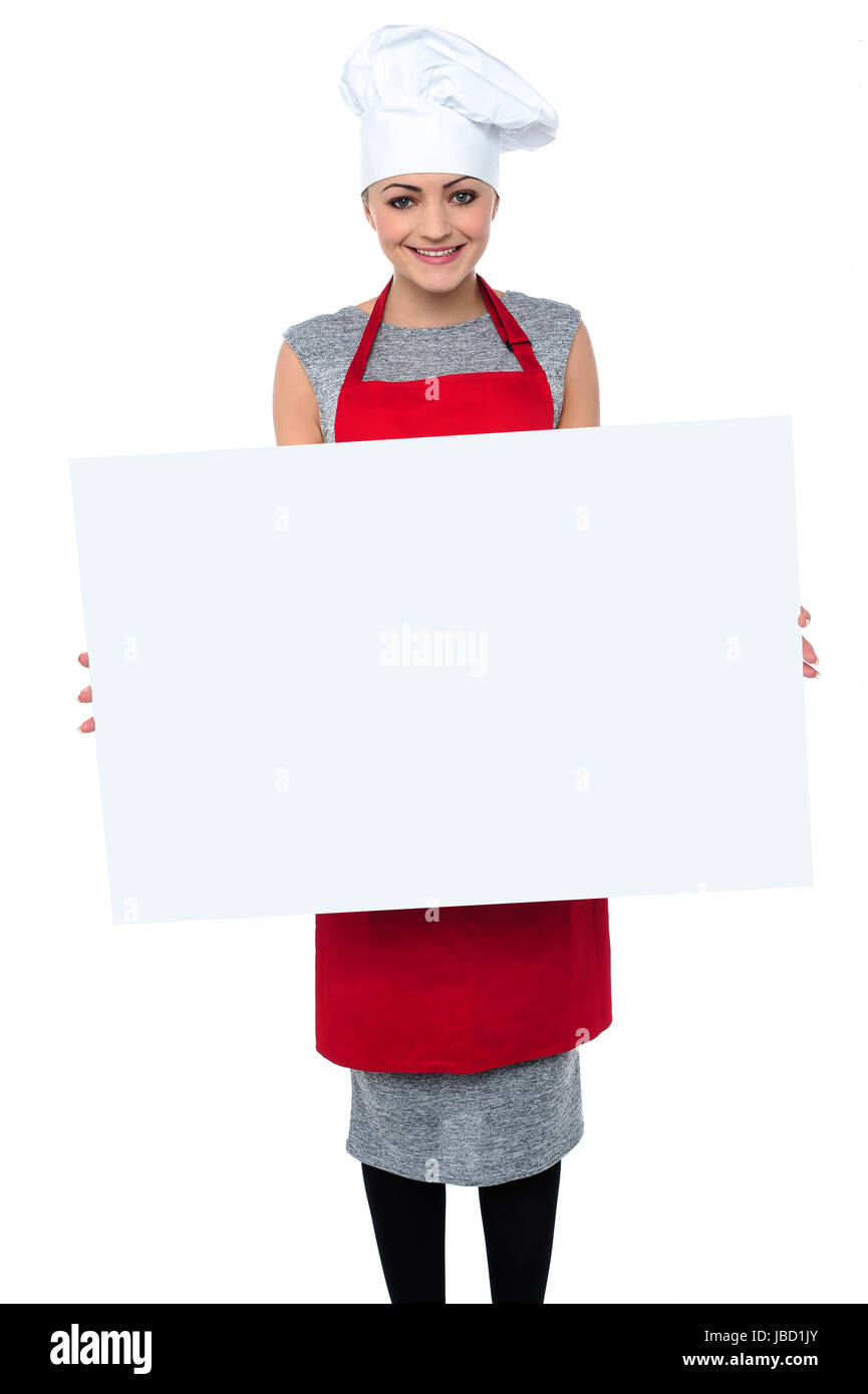 Charmante junge Bäcker-Dame ein leeres Whiteboard anzeigen Stockfoto