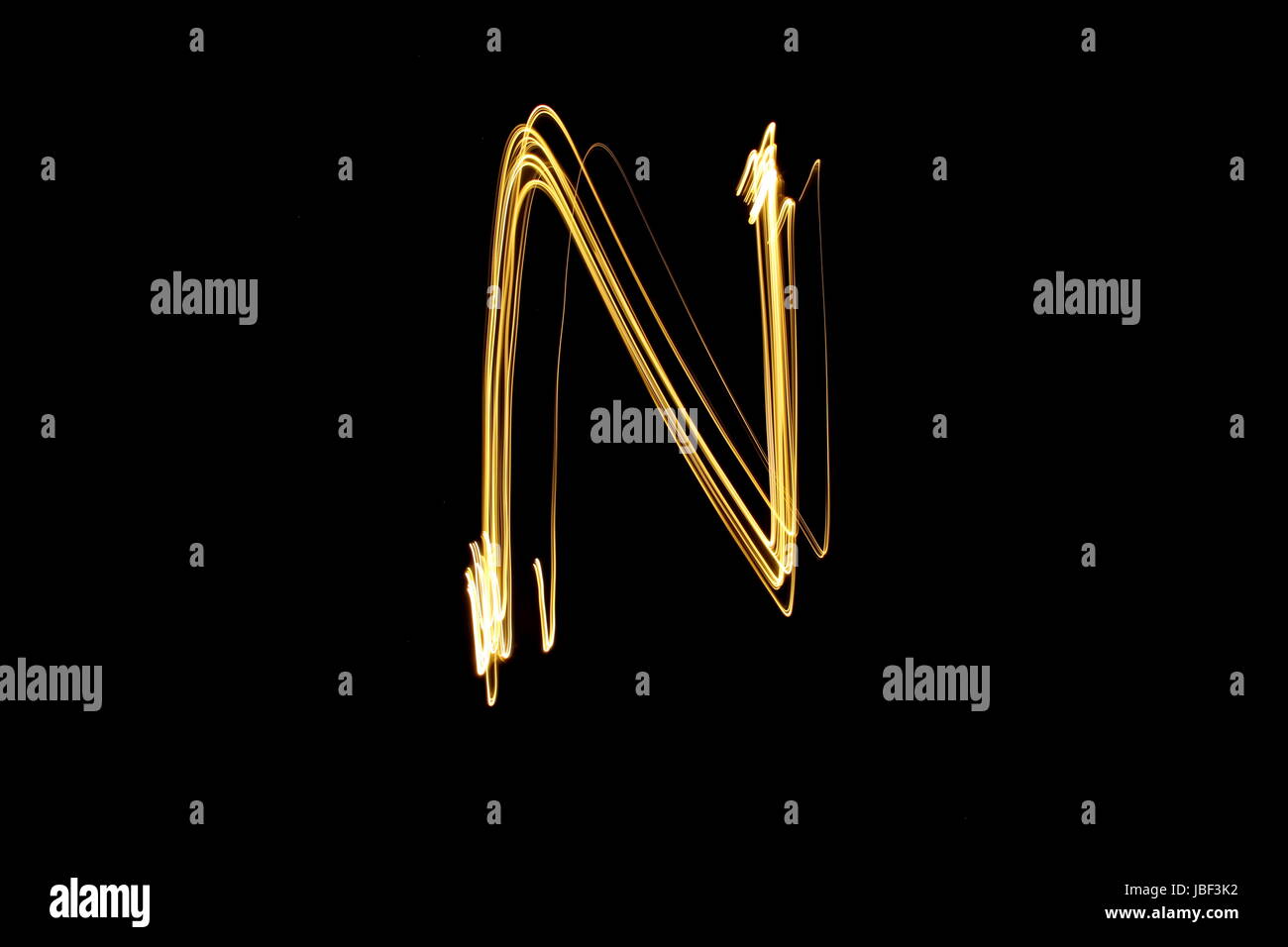 Goldene Buchstaben N, Licht Malerei Fotografie, Alphabet-Serie, vor schwarzem Hintergrund Stockfoto