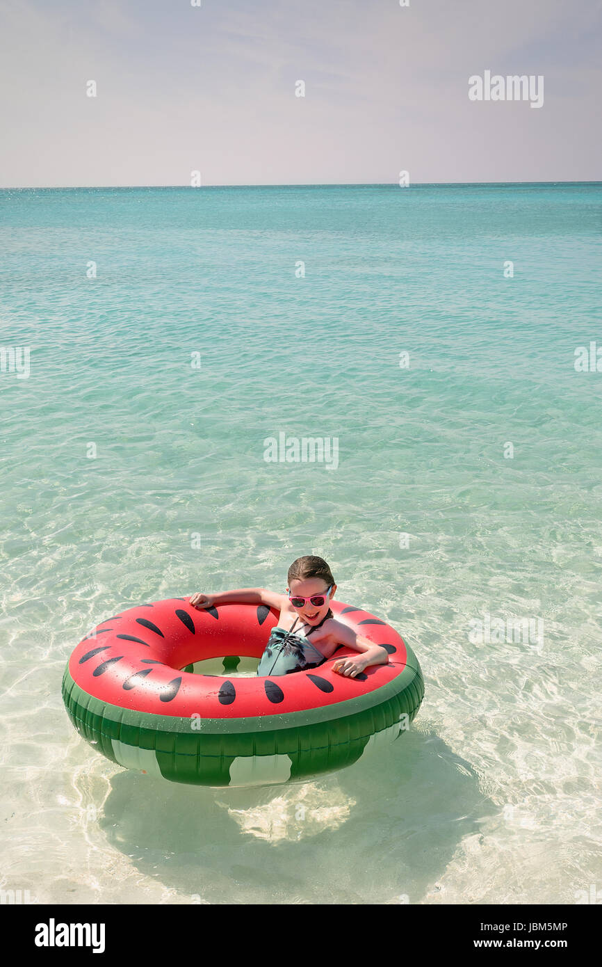 Porträt-Mädchen in Wassermelone aufblasbaren Ring im sonnigen tropischen Meer schweben Stockfoto