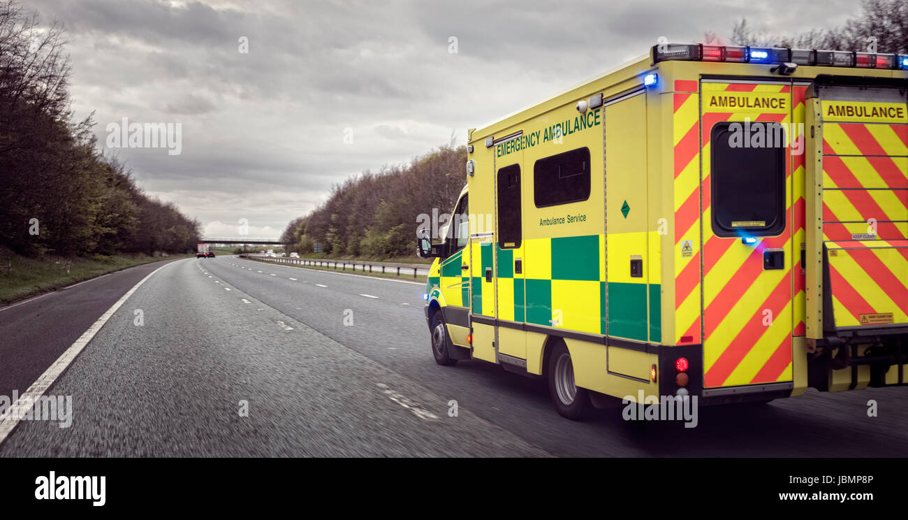 Britische Krankenwagen Reaktion auf einen Notfall bei gefährlichen Schlechtwetter Fahrbedingungen auf einer UK-Autobahn Stockfoto