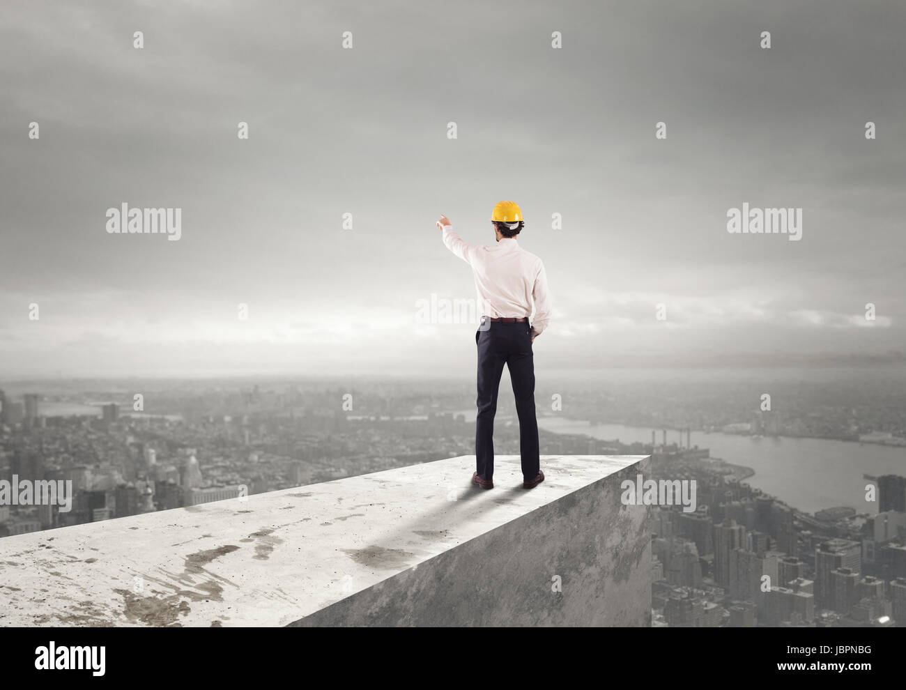 Geschäftsmann mit Helm zeigt die richtige Richtung Stockfoto