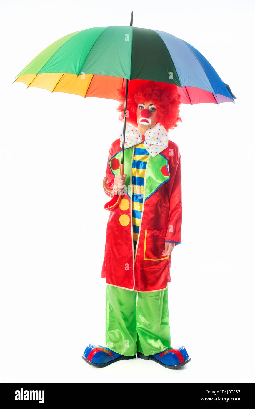Trauriger Clown mit Schirm Stockfoto