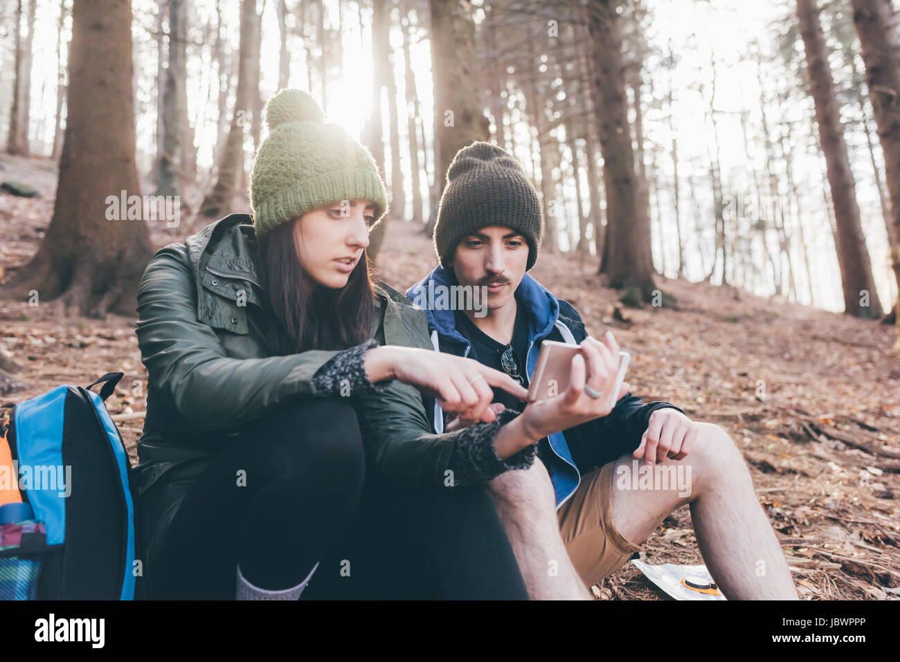 Wandern paar in Wald Blick auf Smartphone, Monte San Primo, Italien Stockfoto