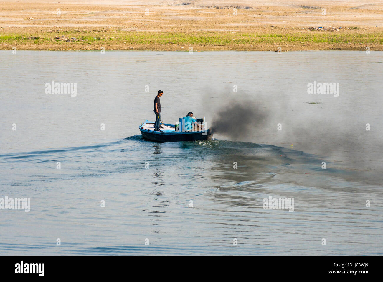 Der Motor eines Motorboot produziert schwarze Abgase auf dem heiligen Fluss Ganges Stockfoto