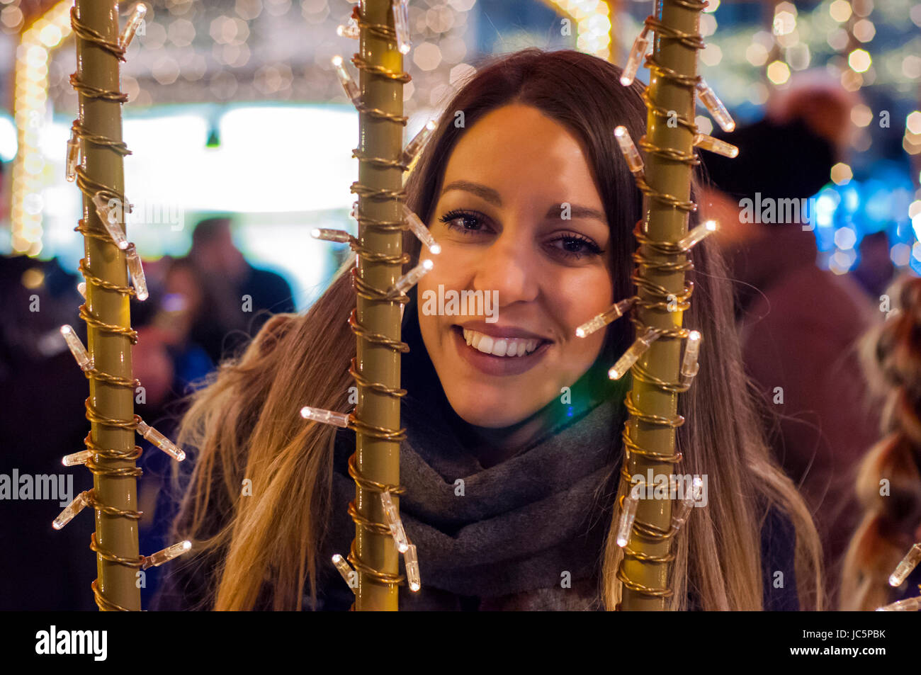 Glückliche Frau Gefühl die städtischen Christmas-Stimmung in der Nacht. Glückliche Frau blickte mit Weihnachten Licht in der Nacht Stockfoto