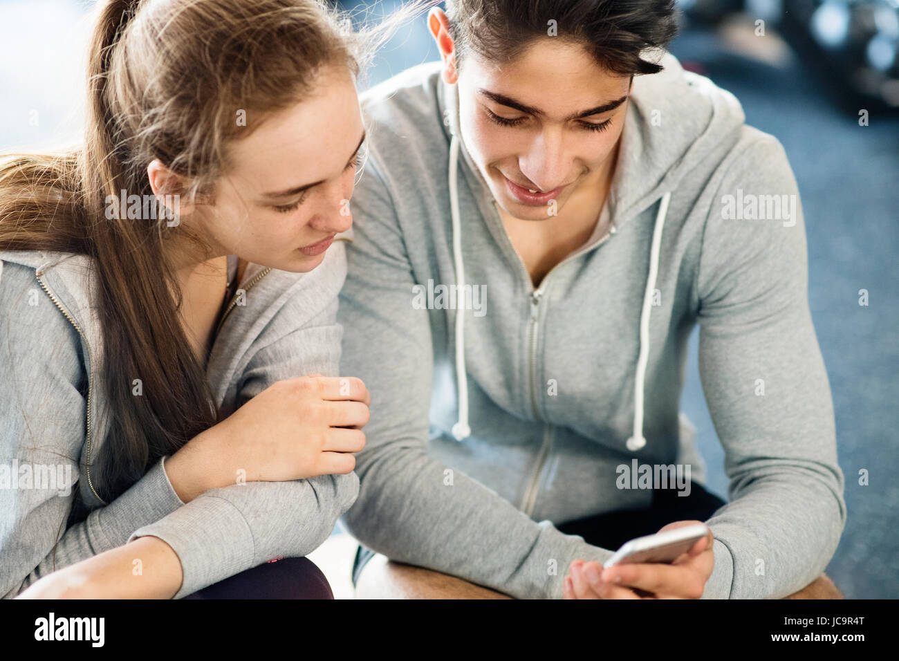 Passen Sie paar in modernen Crossfit Gym mit Smartphone. Stockfoto