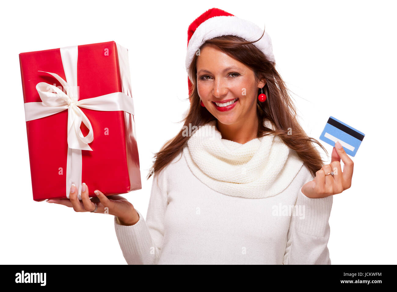 Anziehend-Frau Mit Roter Nikolausmütze Mit Einem Großen Roten Weihnachtsgeschenk Und Bank-Karte Kreditkarte Isoliert Auf Weiß Freisteller Textfreiraum Stockfoto