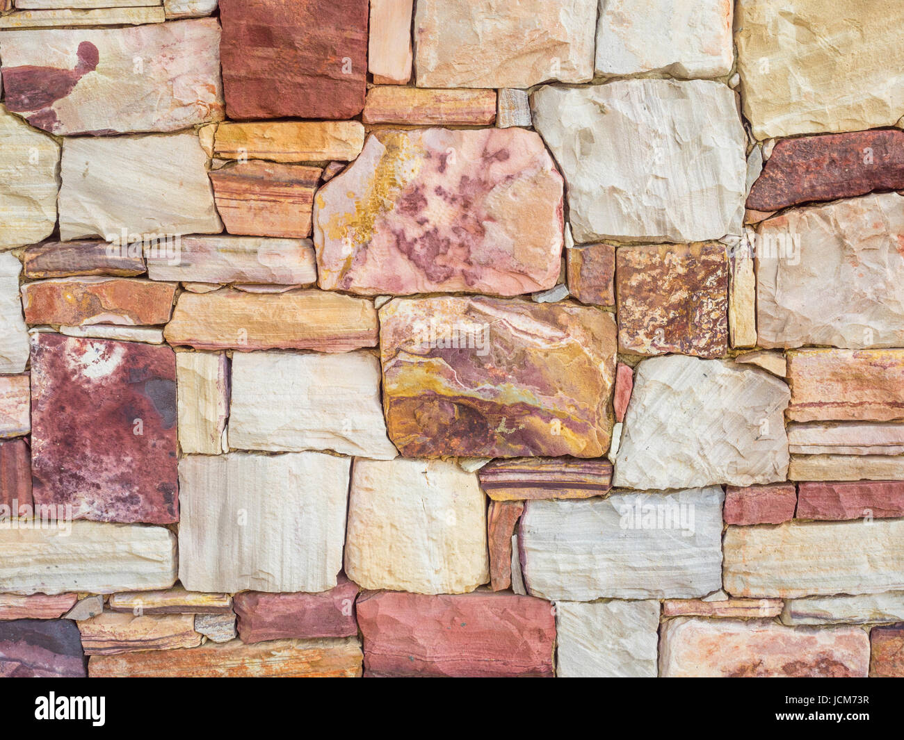 Einen Felsen Wand Hintergrund aus bunten australische Felsen gemacht. Stockfoto