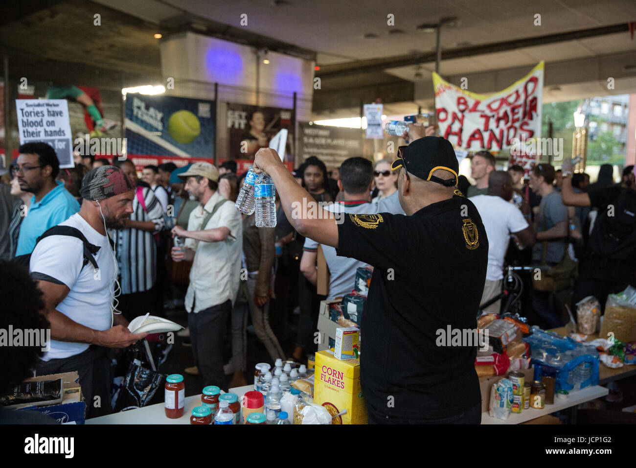 London, UK. 16. Juni 2017. Ein Mann bietet Getränke an die Mitglieder der Gemeinschaft der North Kensington Teilnahme an einer Demonstration zu verlangen, dass die Verantwortlichen für das Feuer am Grenfell Turm rechenschaftspflichtigen Pass unter der Westway stattfinden. Bildnachweis: Mark Kerrison/Alamy Live-Nachrichten Stockfoto